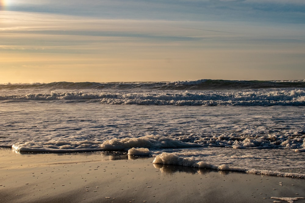 a beach with waves coming in to shore