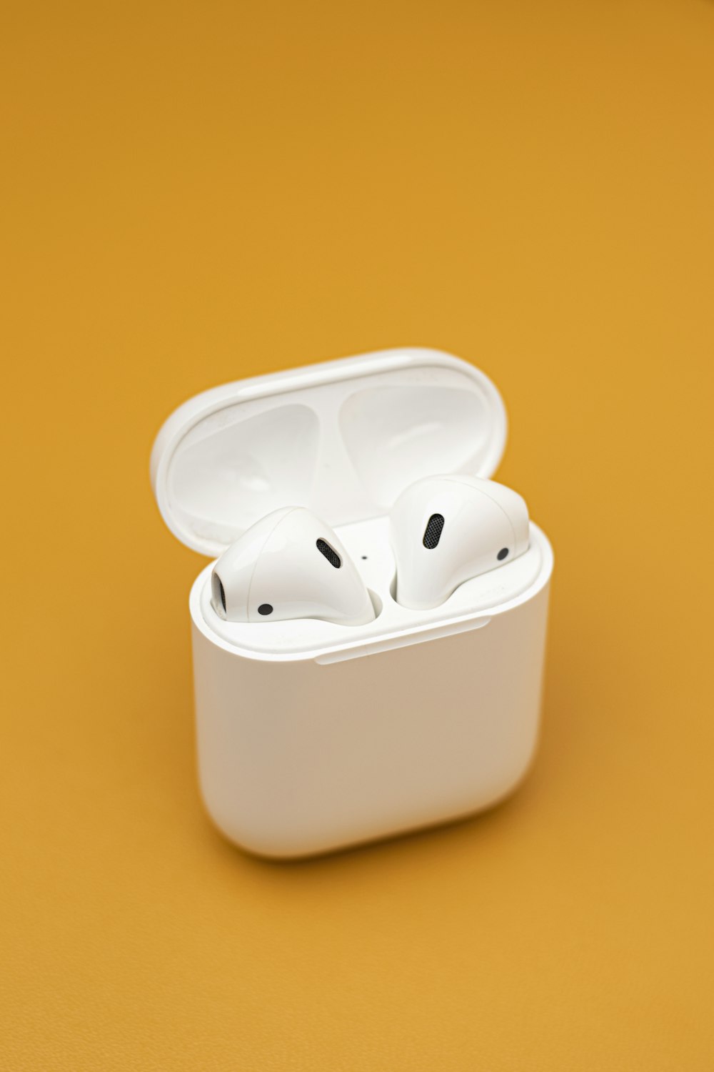 a pair of white airpods sitting in a white case