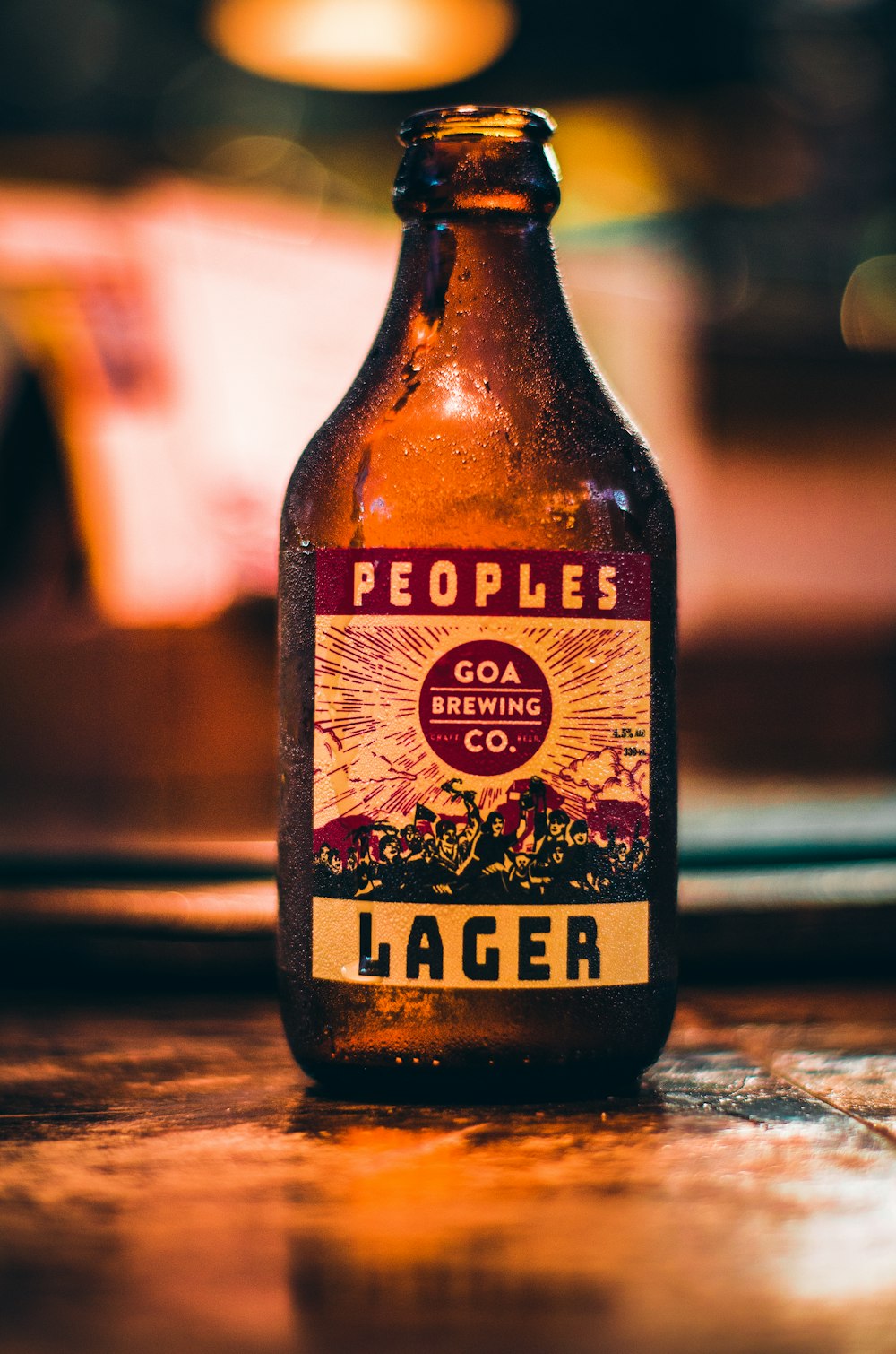 a beer bottle sitting on top of a wooden table