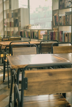 Empty tables and chairs in a school library, the kind of shared space a new Henderson campus would need to plan for