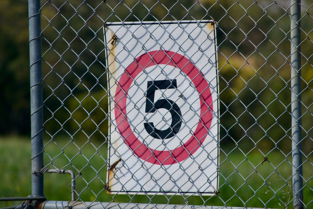 a close up of a sign on a fence