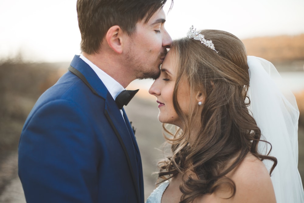 a man and a woman looking at the camera