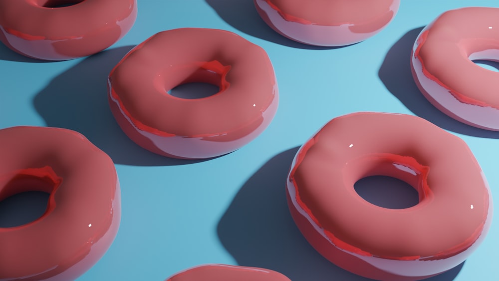 a group of doughnuts sitting on top of a blue surface