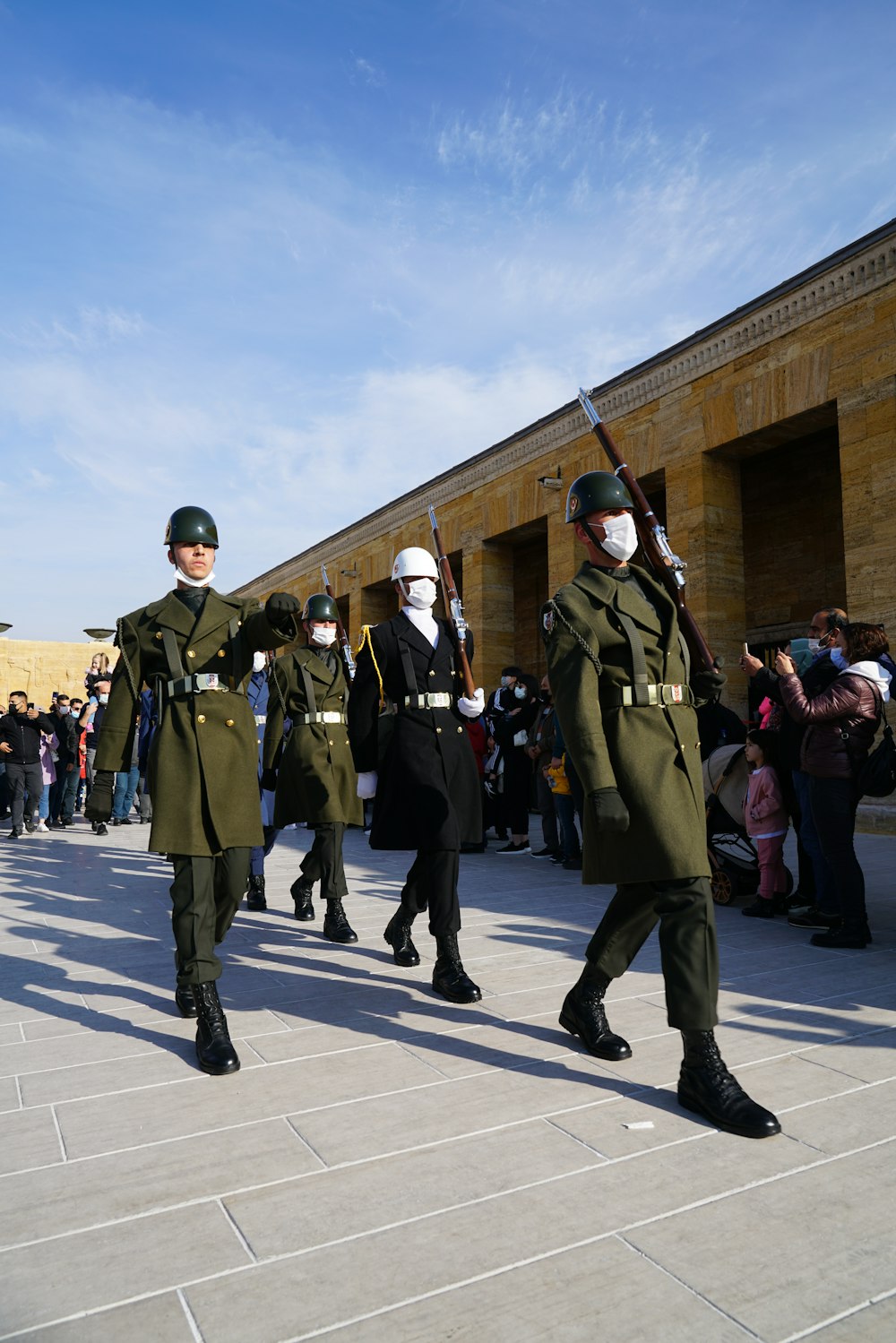 a group of men in military uniforms walking down a street