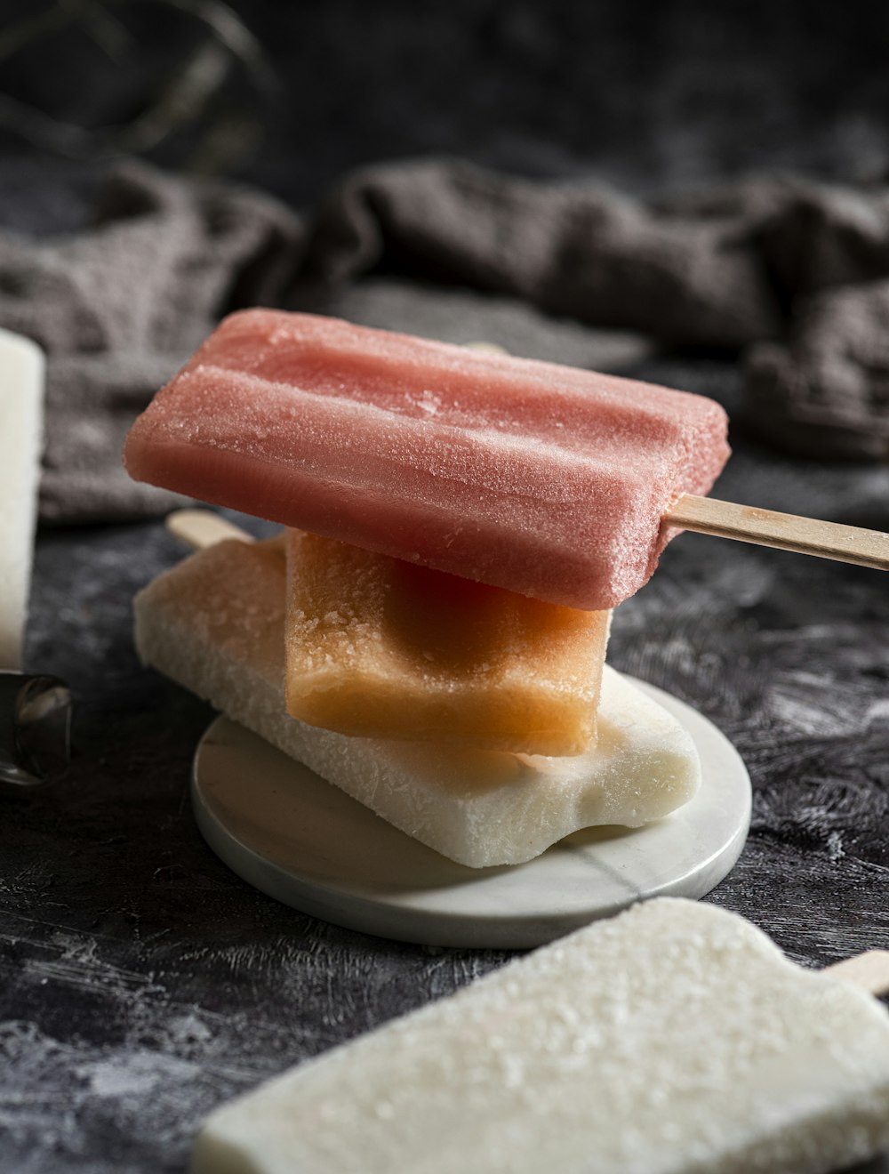 a popsicle sitting on top of a white plate