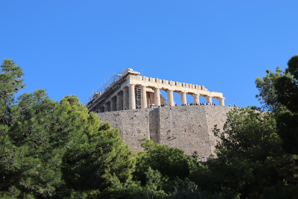 a very tall building sitting on top of a hill