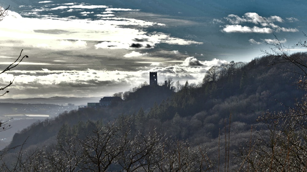 a view of a mountain with a clock tower in the distance