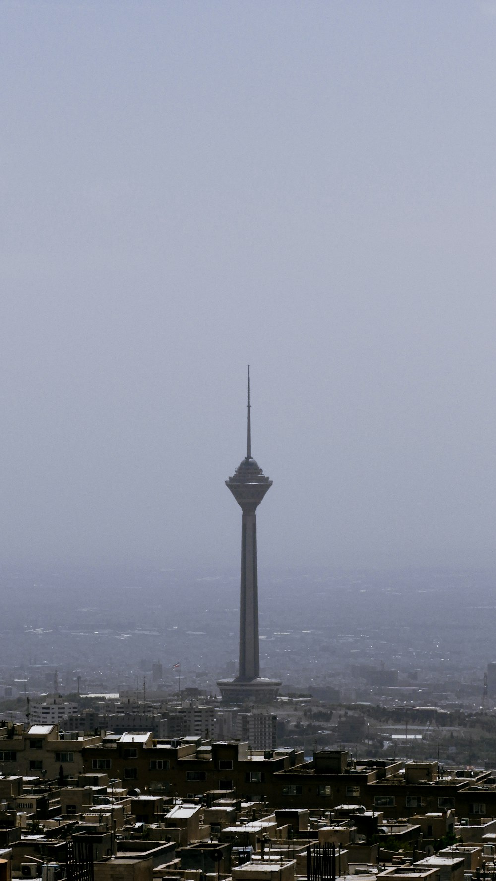 a very tall tower towering over a city