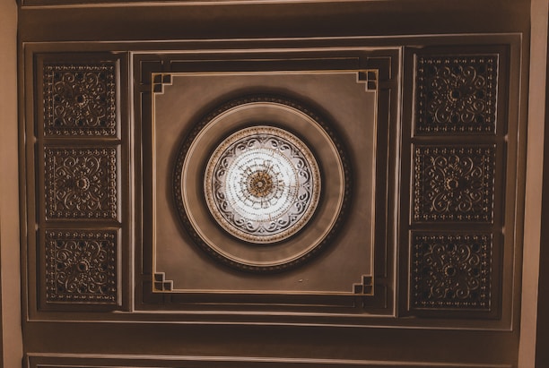 Delicate plaster rosette with classic Louis XVI style, perfect for ceiling decoration.