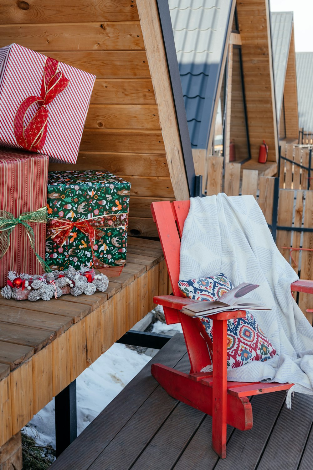 a red chair sitting on top of a wooden deck