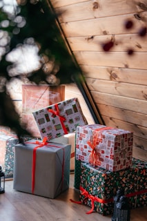 a group of wrapped presents sitting on top of a wooden floor