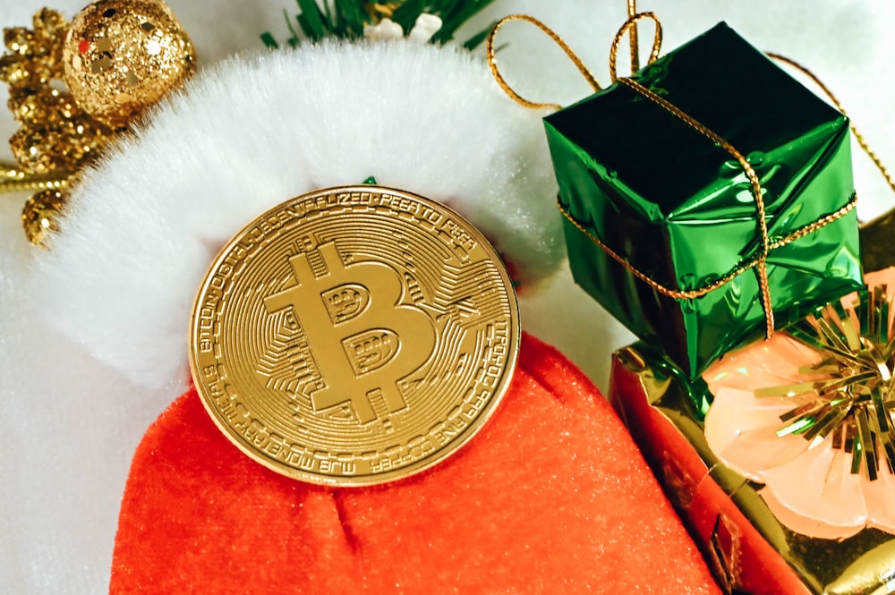 a bitcoin sitting on top of a pile of presents