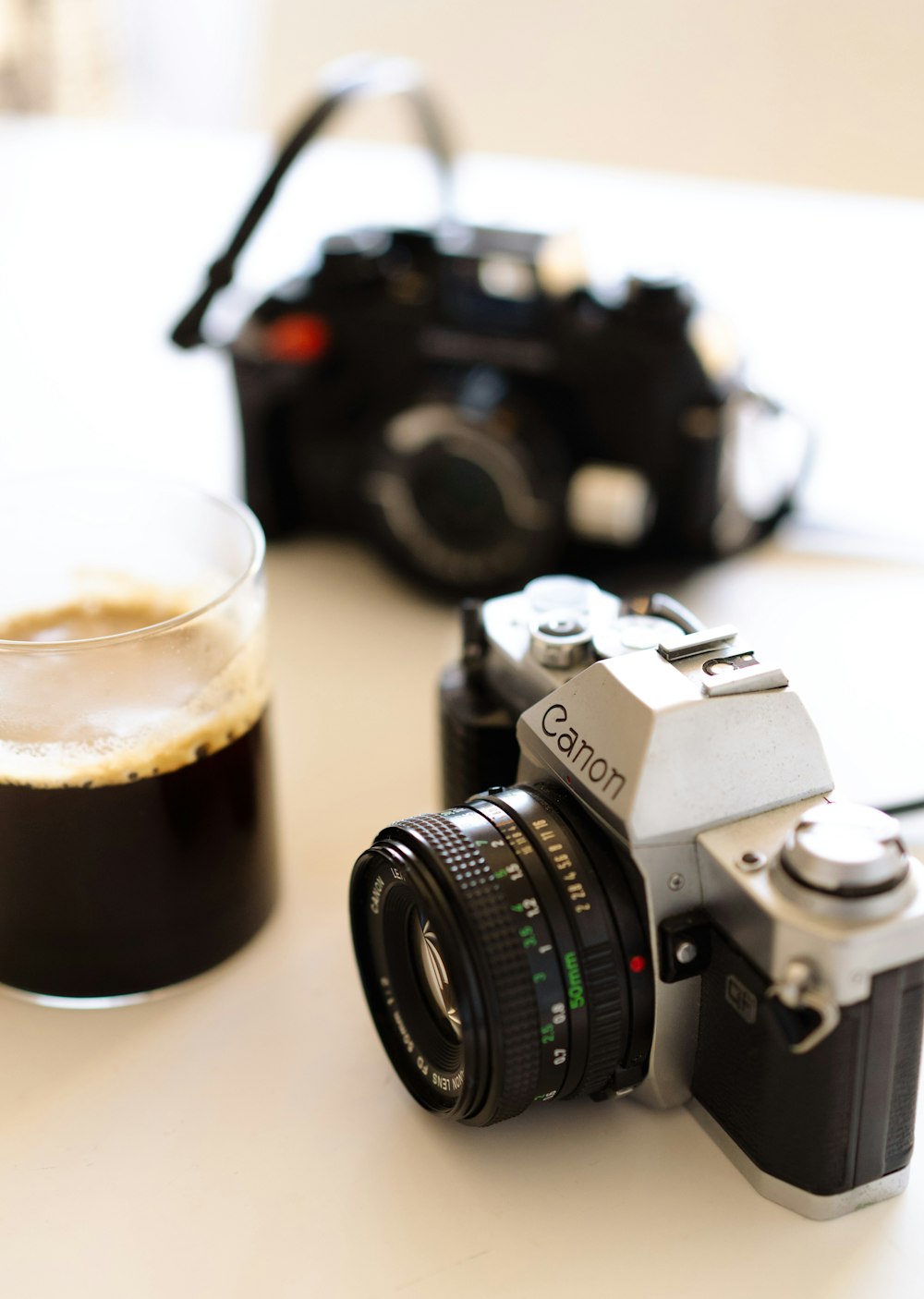 a camera and a glass of beer on a table