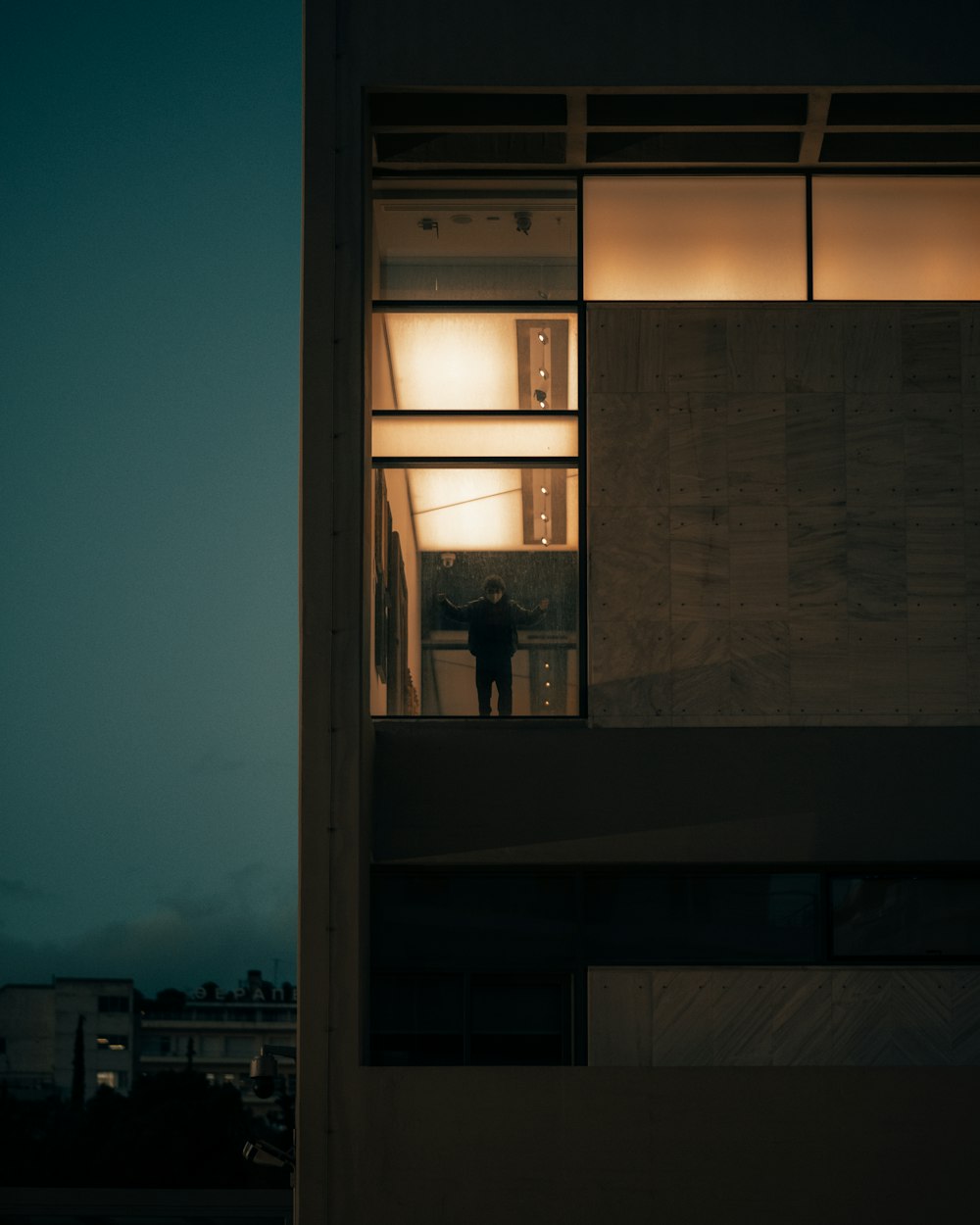 a person standing outside of a building at night