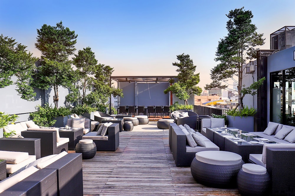 a patio with a lot of couches and tables