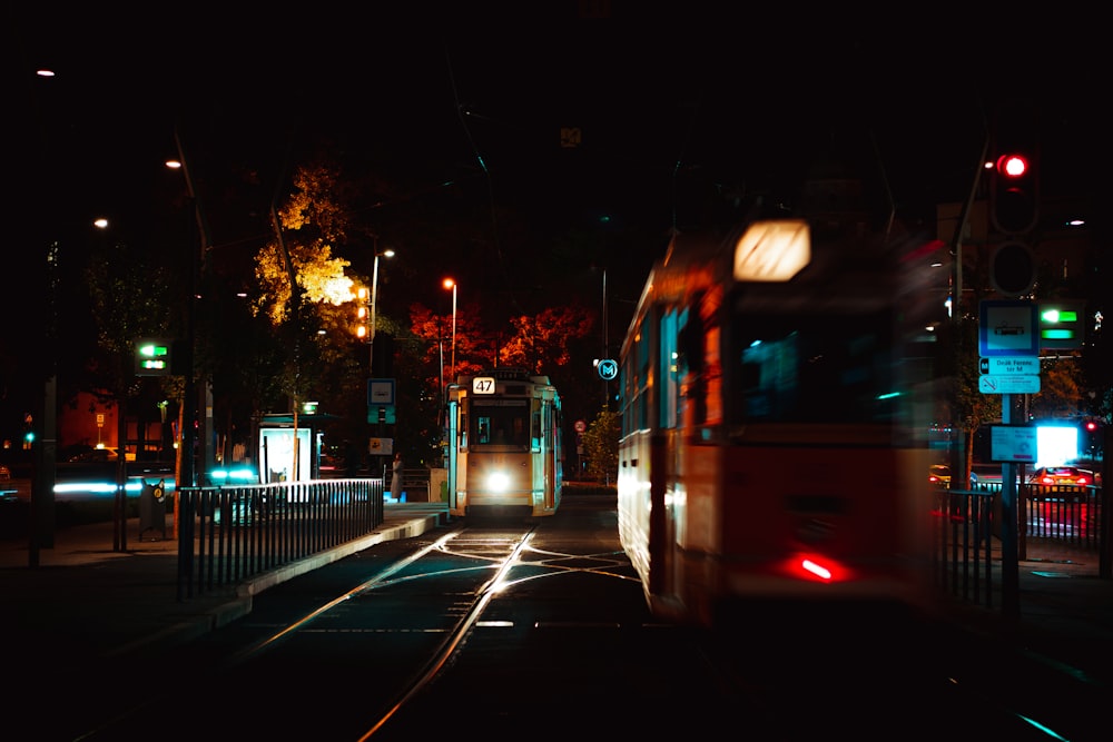 a bus driving down a street at night