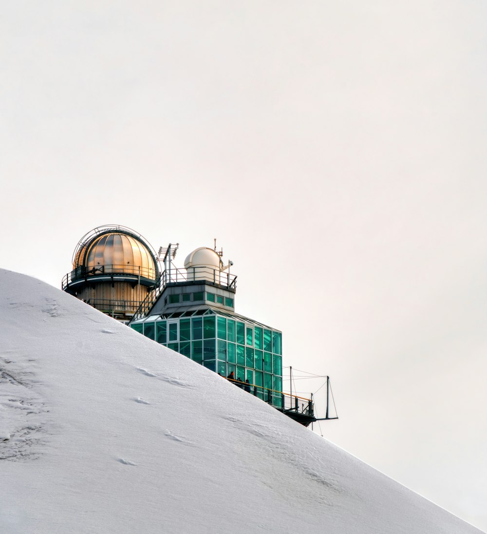 a snow covered hill with a building on top of it