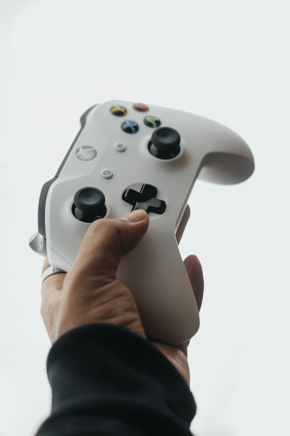 a person holding a video game controller in their hand