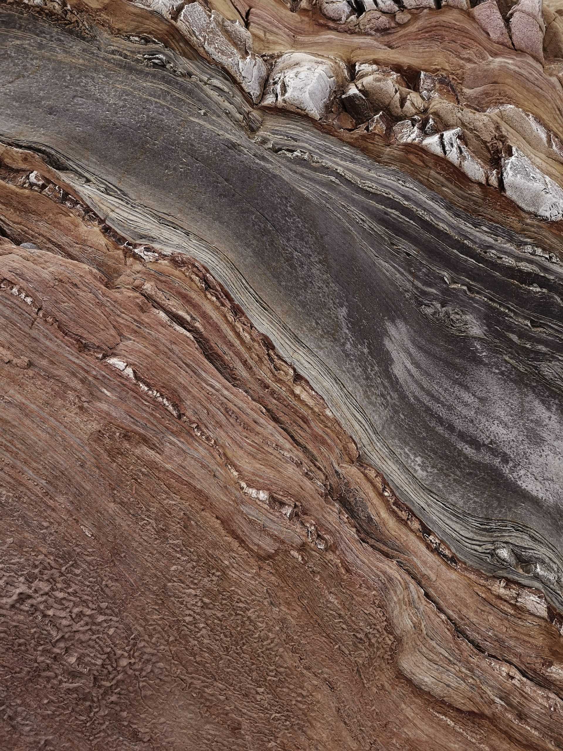 a close up of a rock formation with a bird perched on top of it