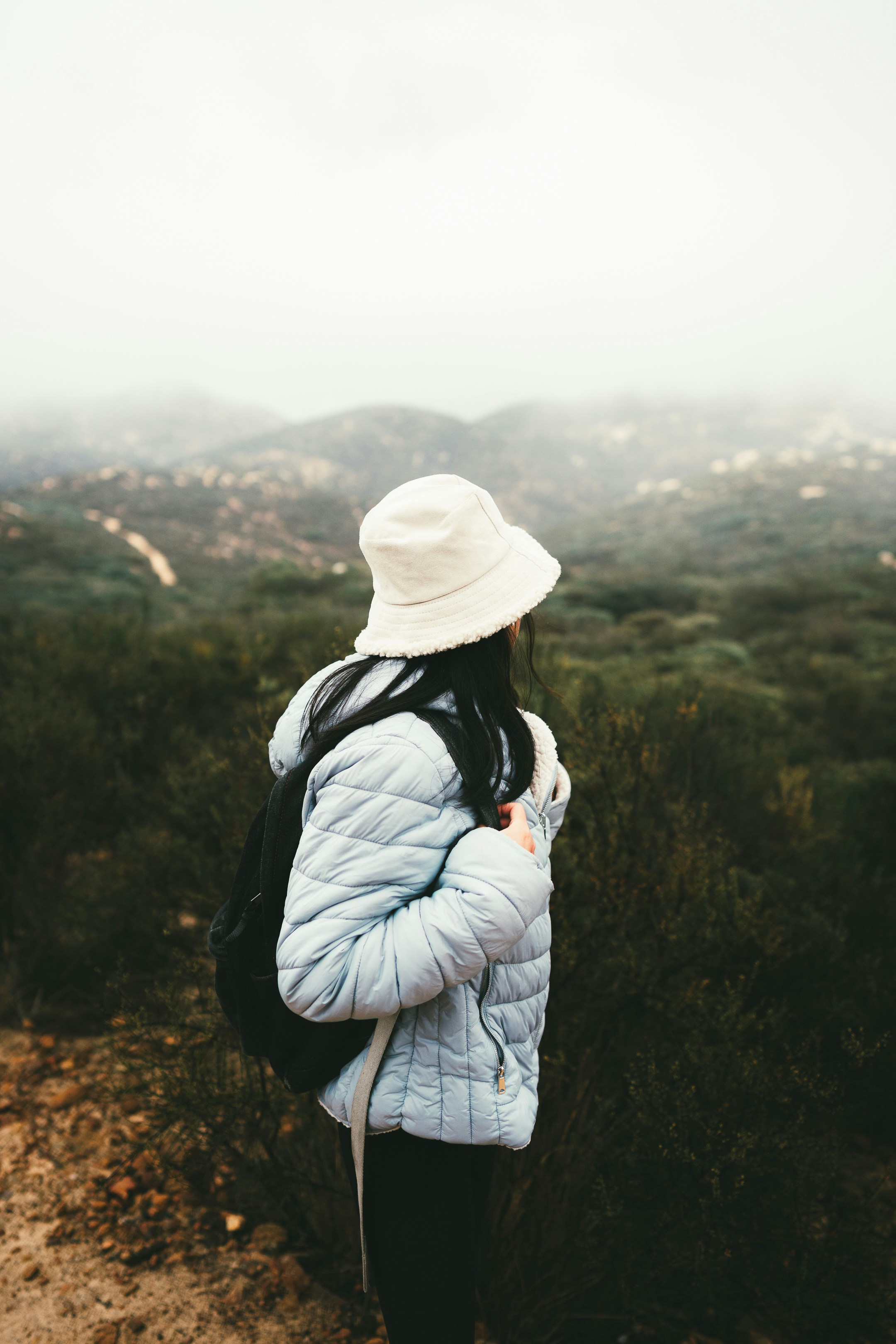 Eine Frau mit weißem Hut und blauer Jacke