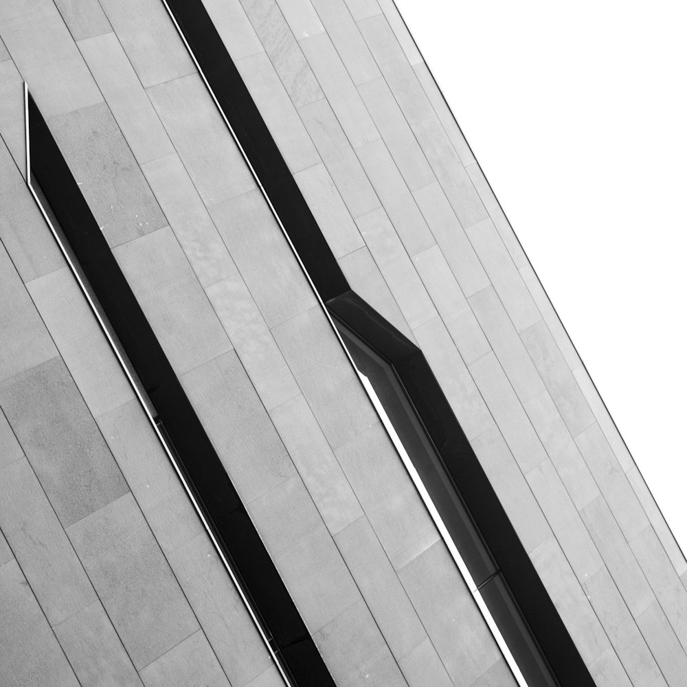 a black and white photo of a clock on the side of a building