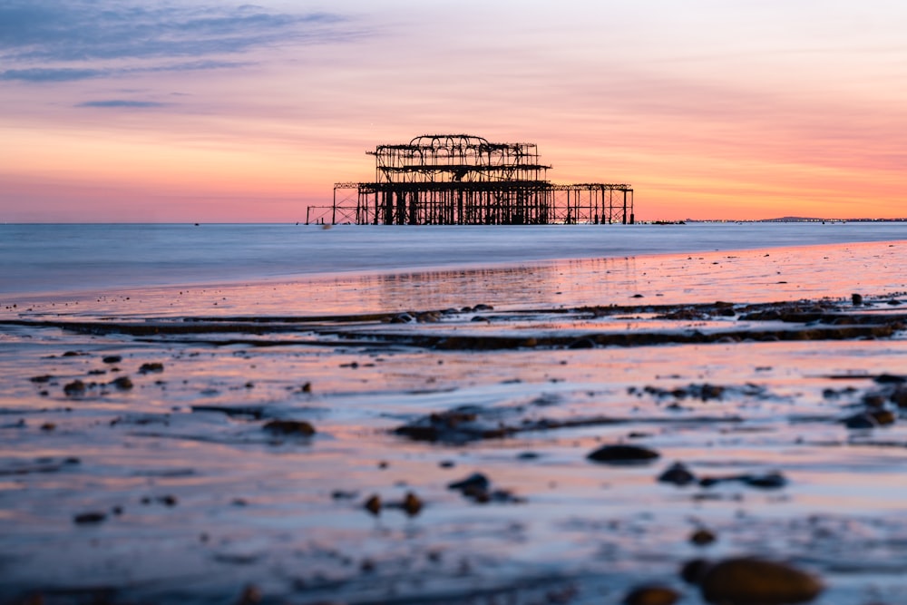 a view of a beach with a structure in the distance