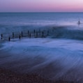 a person standing on a beach next to the ocean