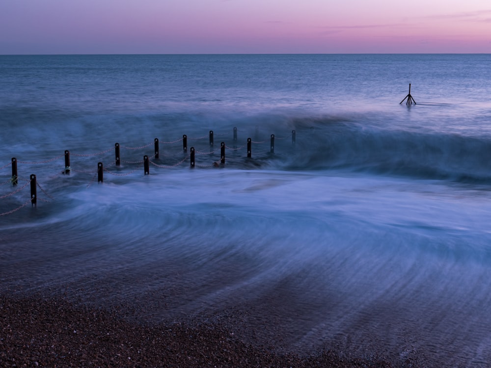 a person standing on a beach next to the ocean