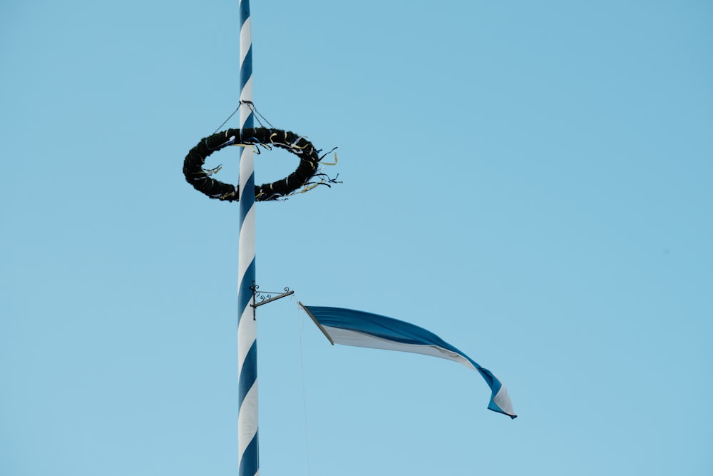 a flag pole with a wreath hanging from it