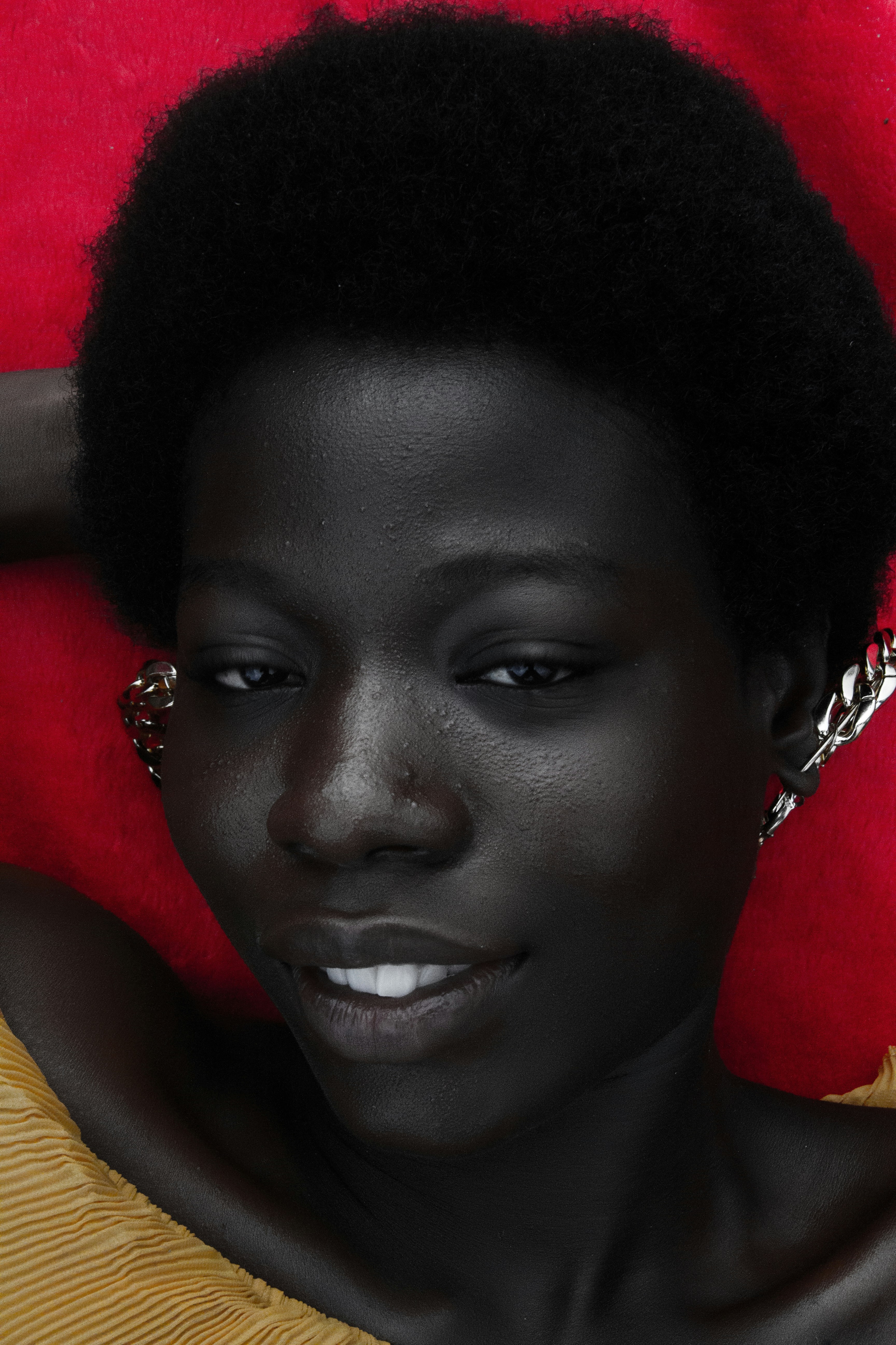 a woman with an afro is posing for a picture