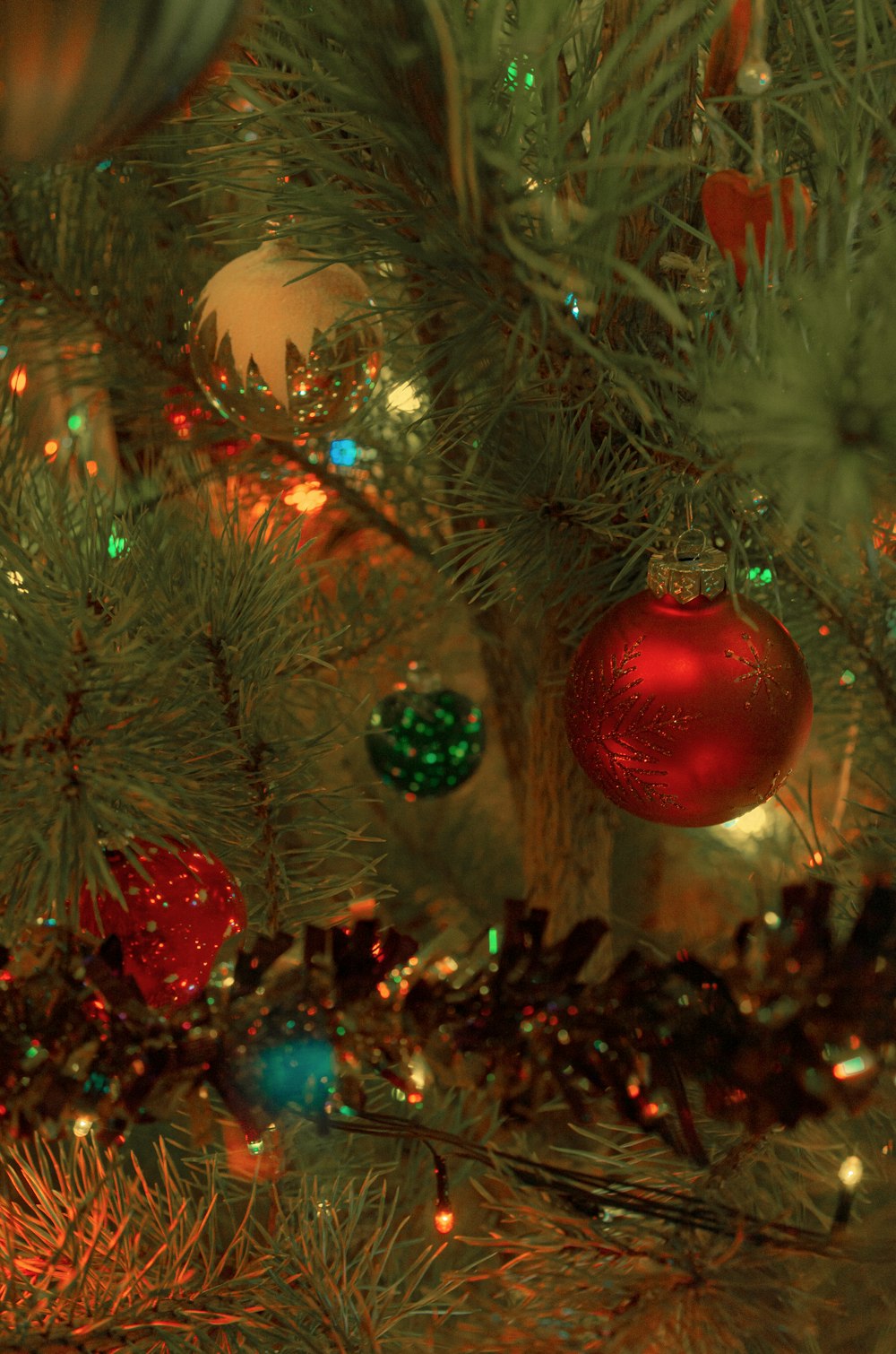 a close up of a christmas tree with ornaments