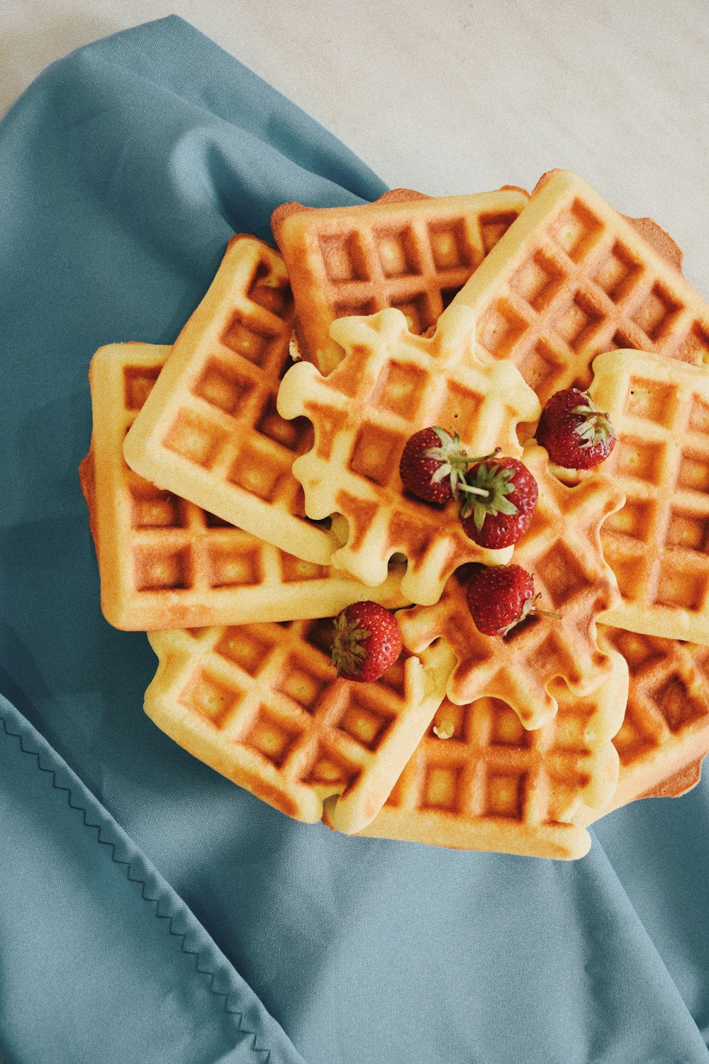 a stack of waffles with strawberries on top