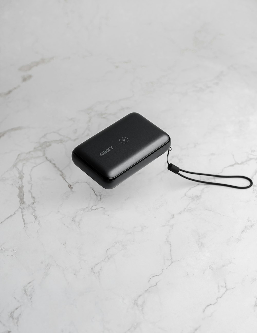 a black power bank sitting on top of a white counter