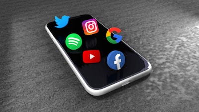 Social media icons floating above a smartphone screen.
