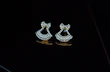 Pair of diamond earrings glowing softly under warm light