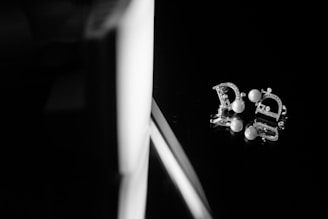 Elegant rhodium plated daily wear earrings displayed on a soft fabric background.