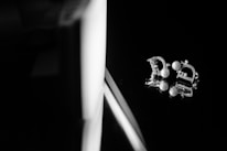 Symmetrical flat lay of sparkling modern cubic zirconia earrings on a cool ivory marble surface.