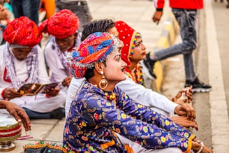 a group of people sitting on the side of a road