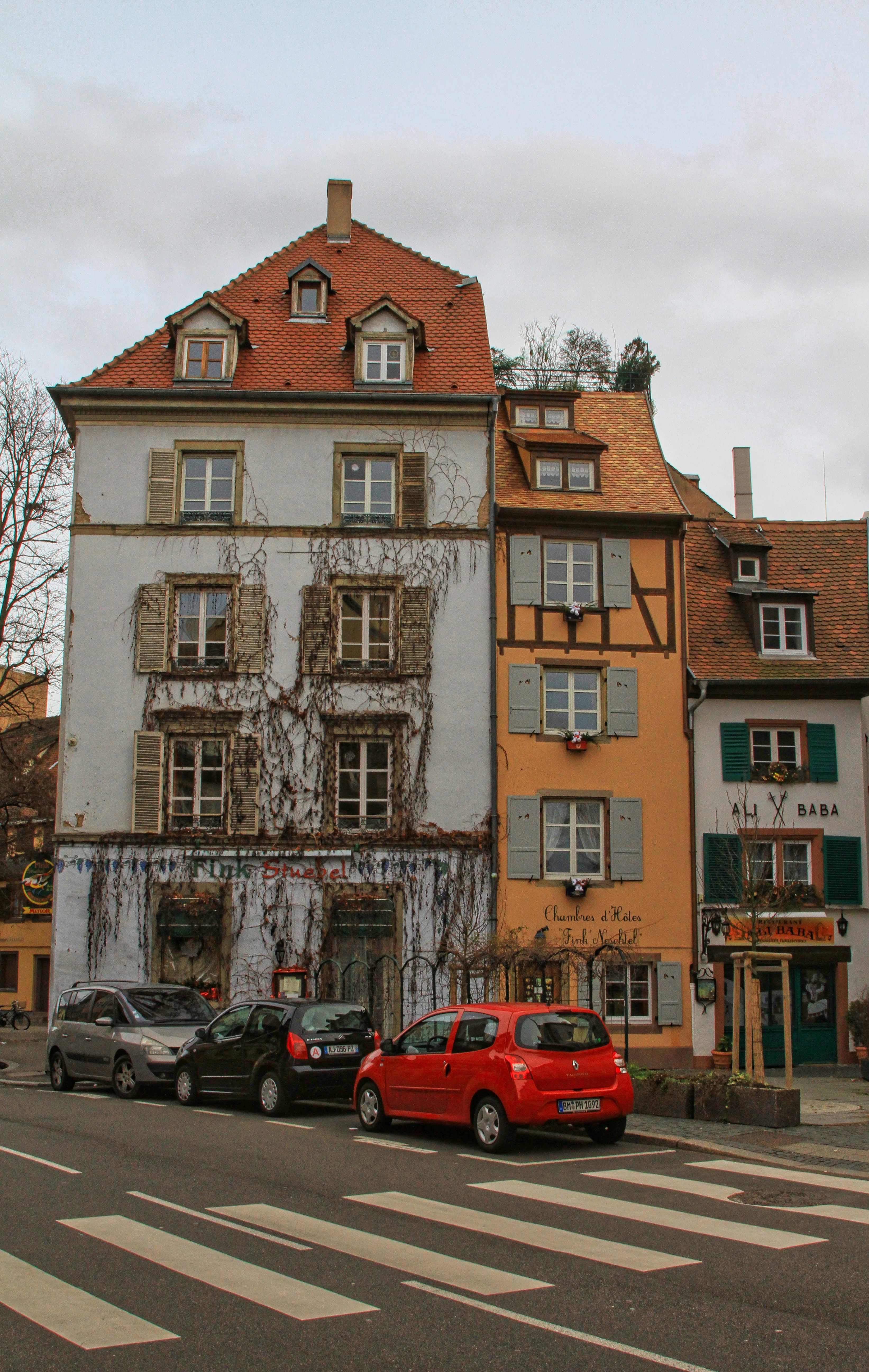 a couple of cars that are parked in front of a building