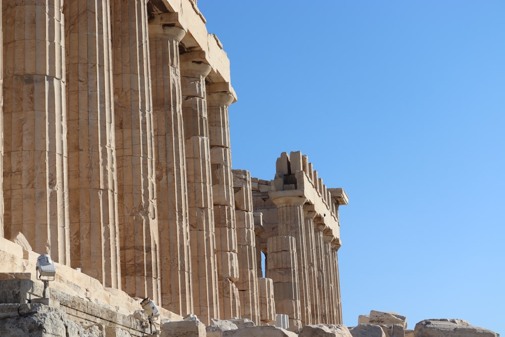 a row of stone columns against a blue sky