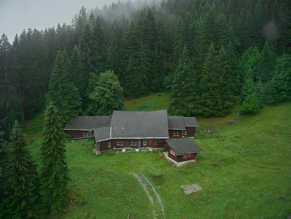 an aerial view of a house in the middle of a forest