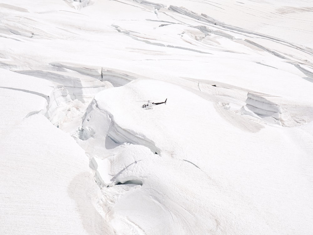 a man riding skis down a snow covered slope