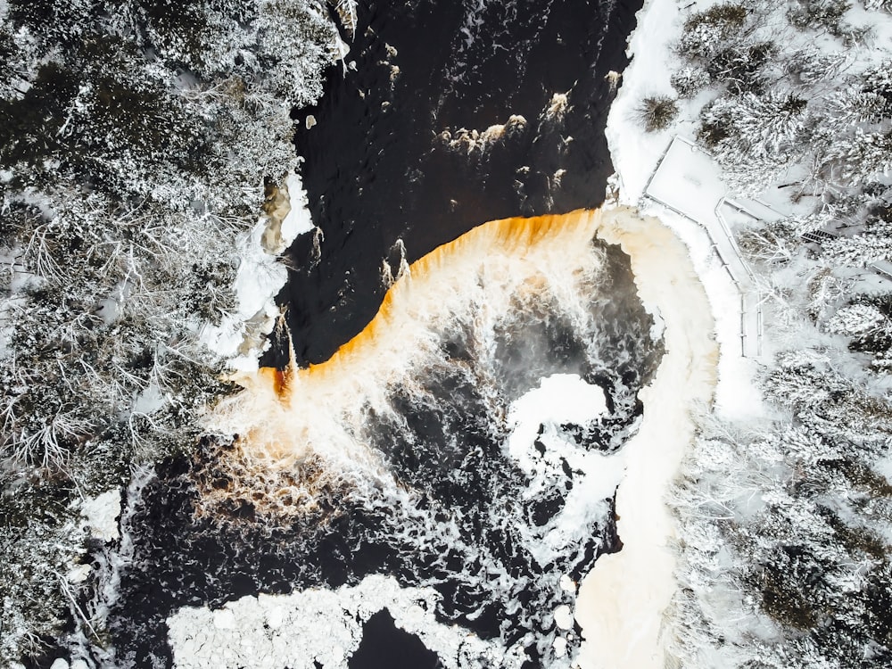 an aerial view of a river in the snow