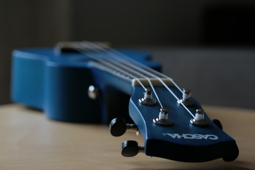 a close up of a guitar neck on a table