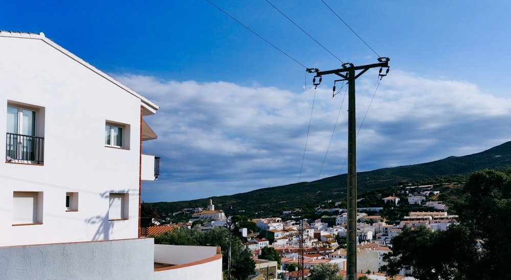 a telephone pole in front of a white building