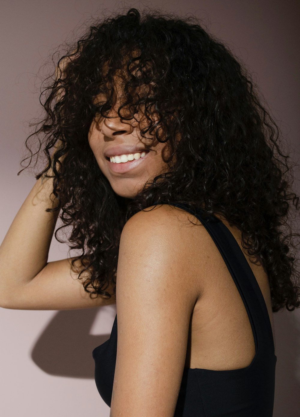 a close up of a person with curly hair