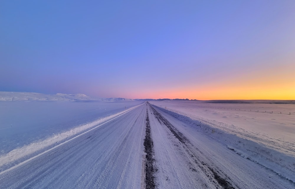 a snow covered road in the middle of nowhere