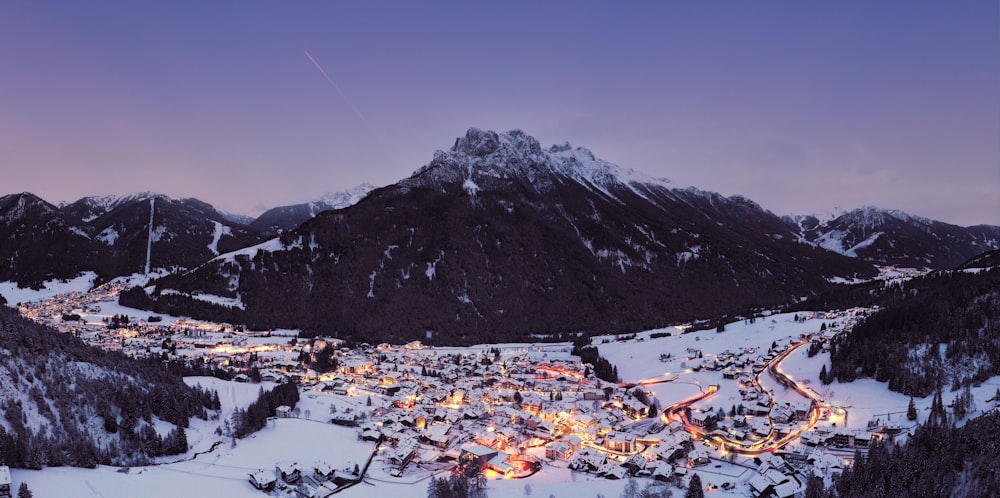 a snowy mountain town lit up at night
