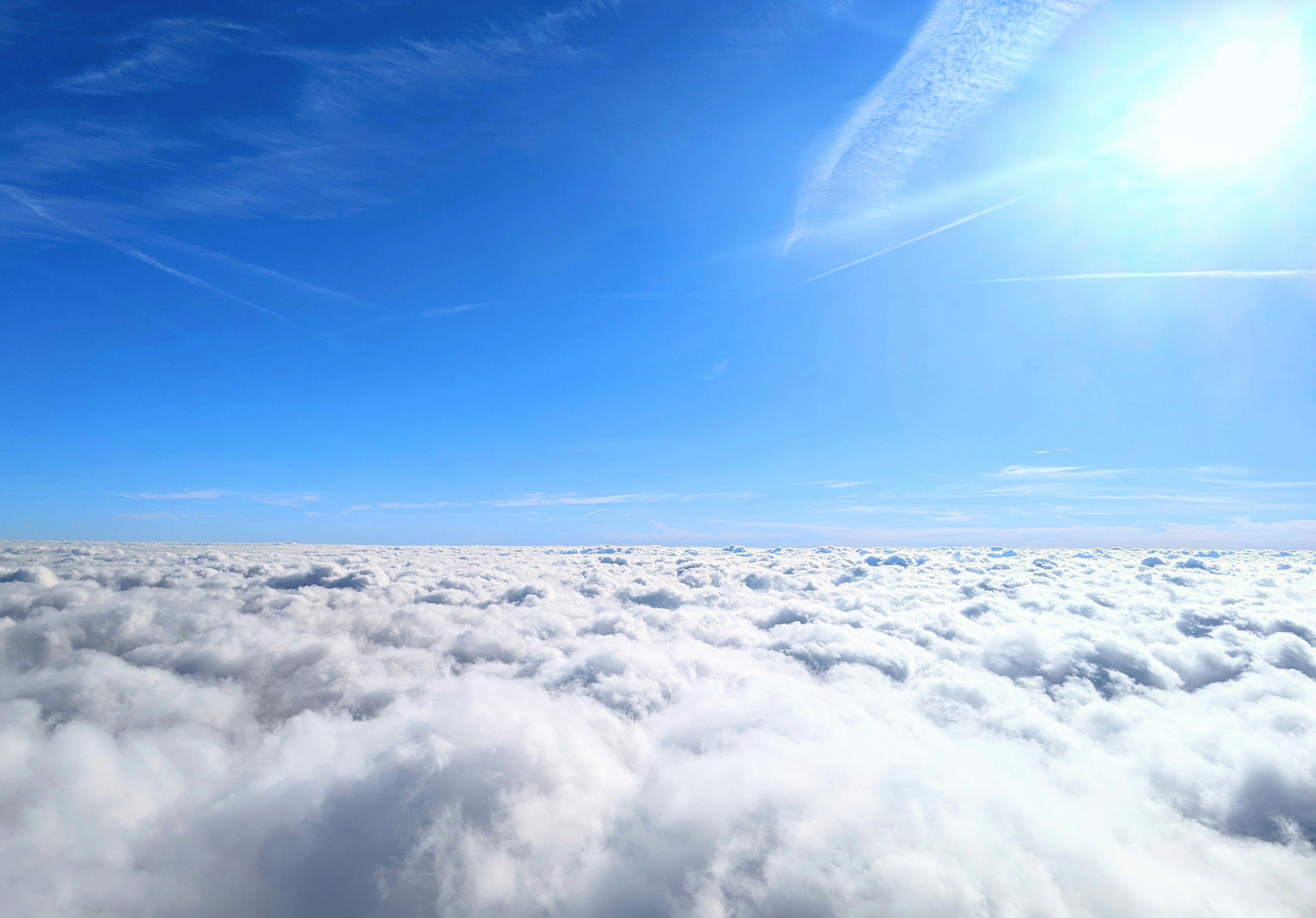 the sun is shining above the clouds in the sky