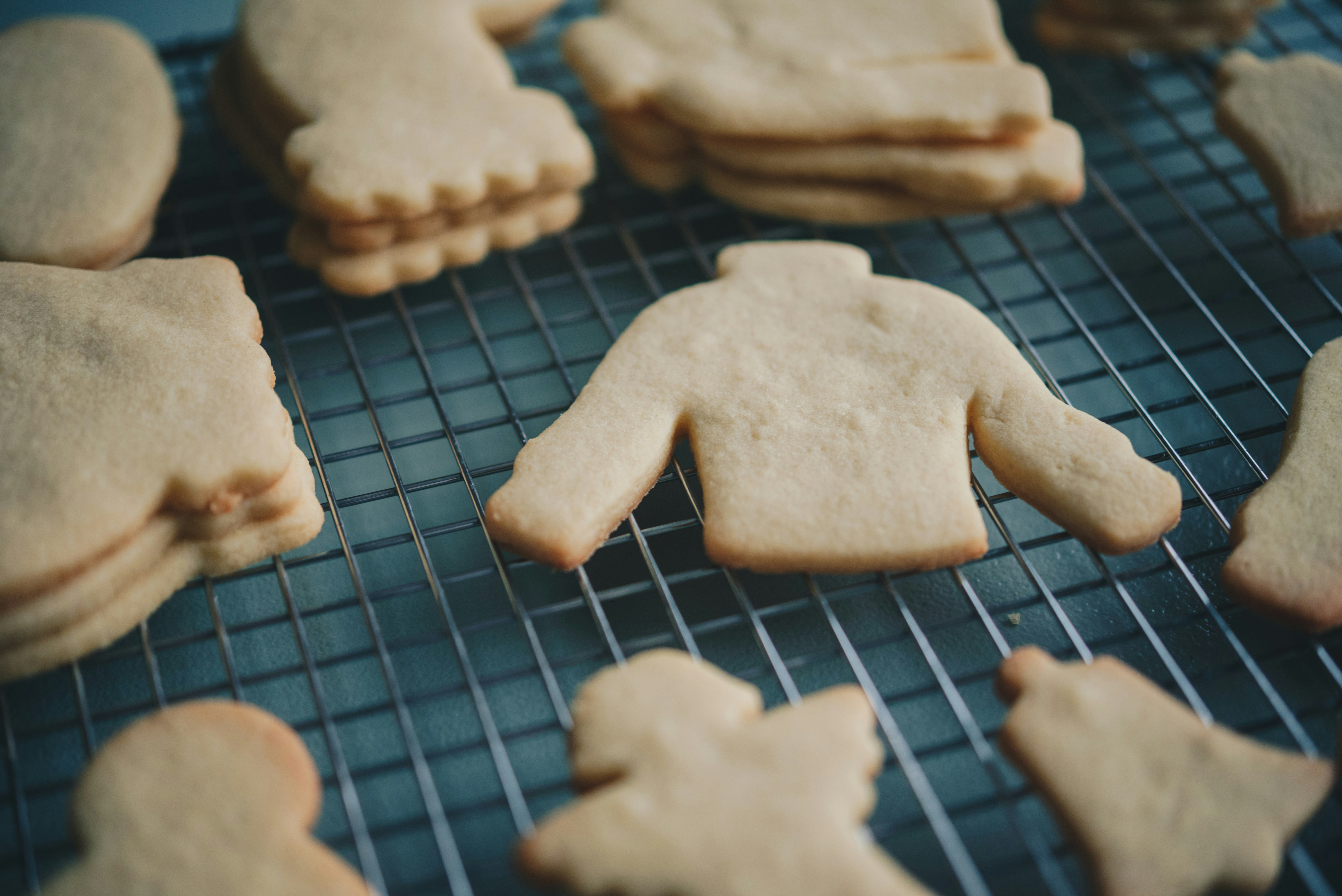 a bunch of cookies that are on a rack, Baking frosted Christmas cookies